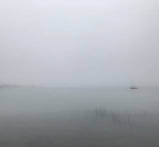 boats and fog and clouds on the lake