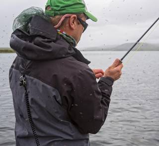 black flies swarming fisherman