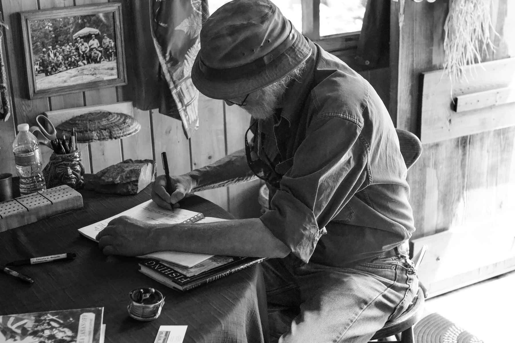 John Gierach signing the guestbook at John Voelker's cabin