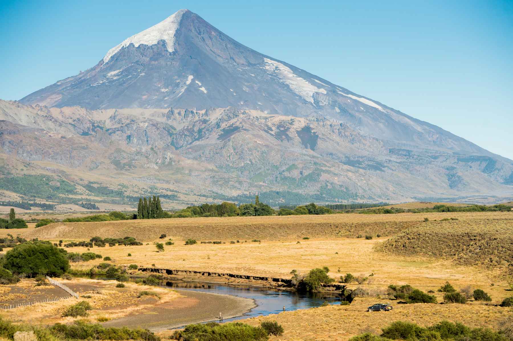 Casting under the watchful eye of the Lanin volcano on the meadows section of the Malleo River (photo: Isaias Miciu). Patagonia - Malleo River Fly Fishing - Lanin Volcano