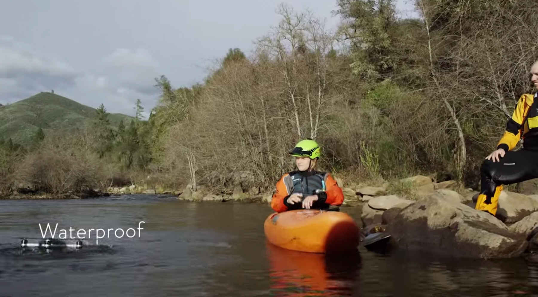 The Lily camera emerges from a river after being tossed in. Lily camera waterproof