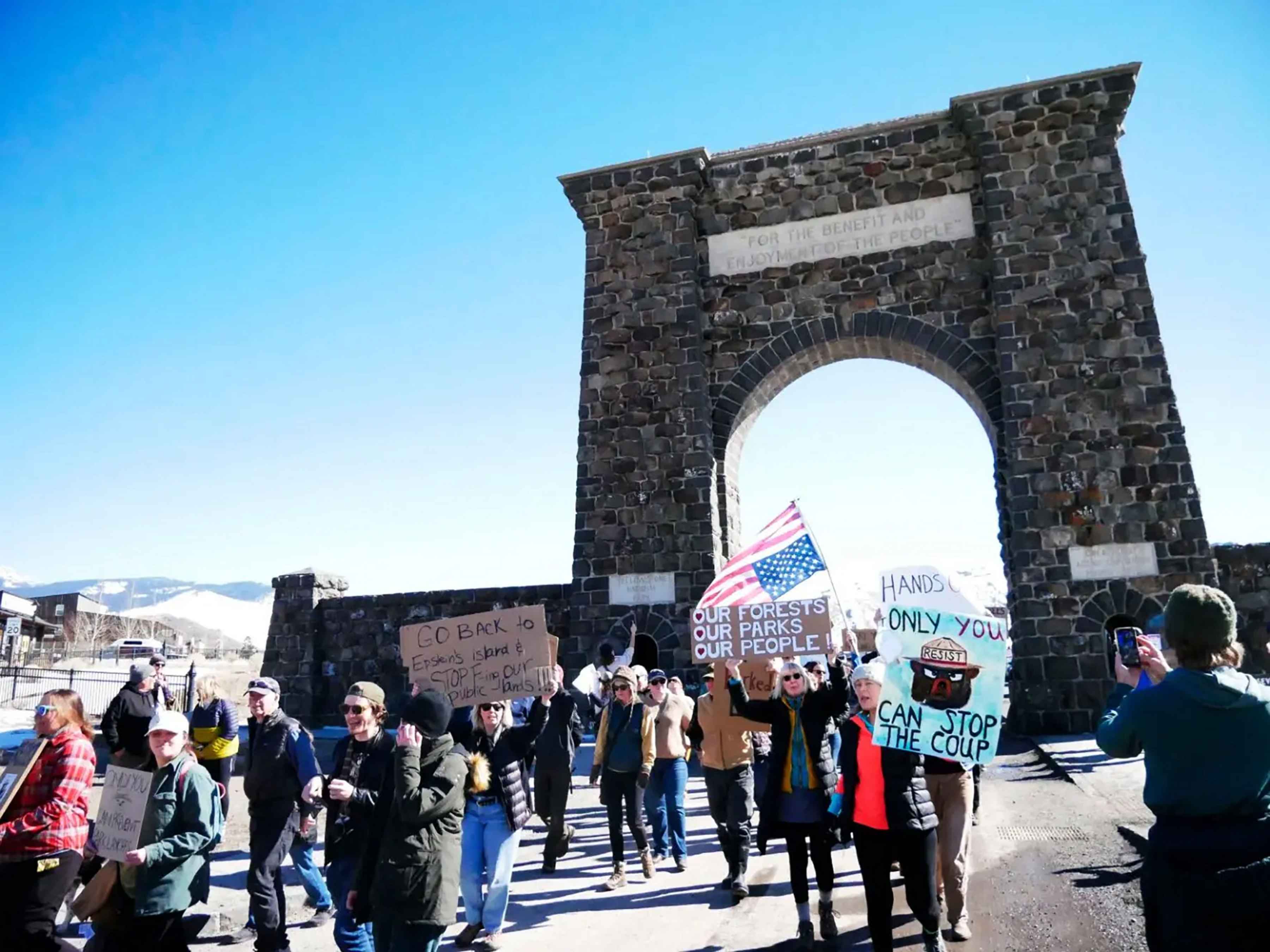 Protesters march around the Roosevelt Arch on March 1 2025