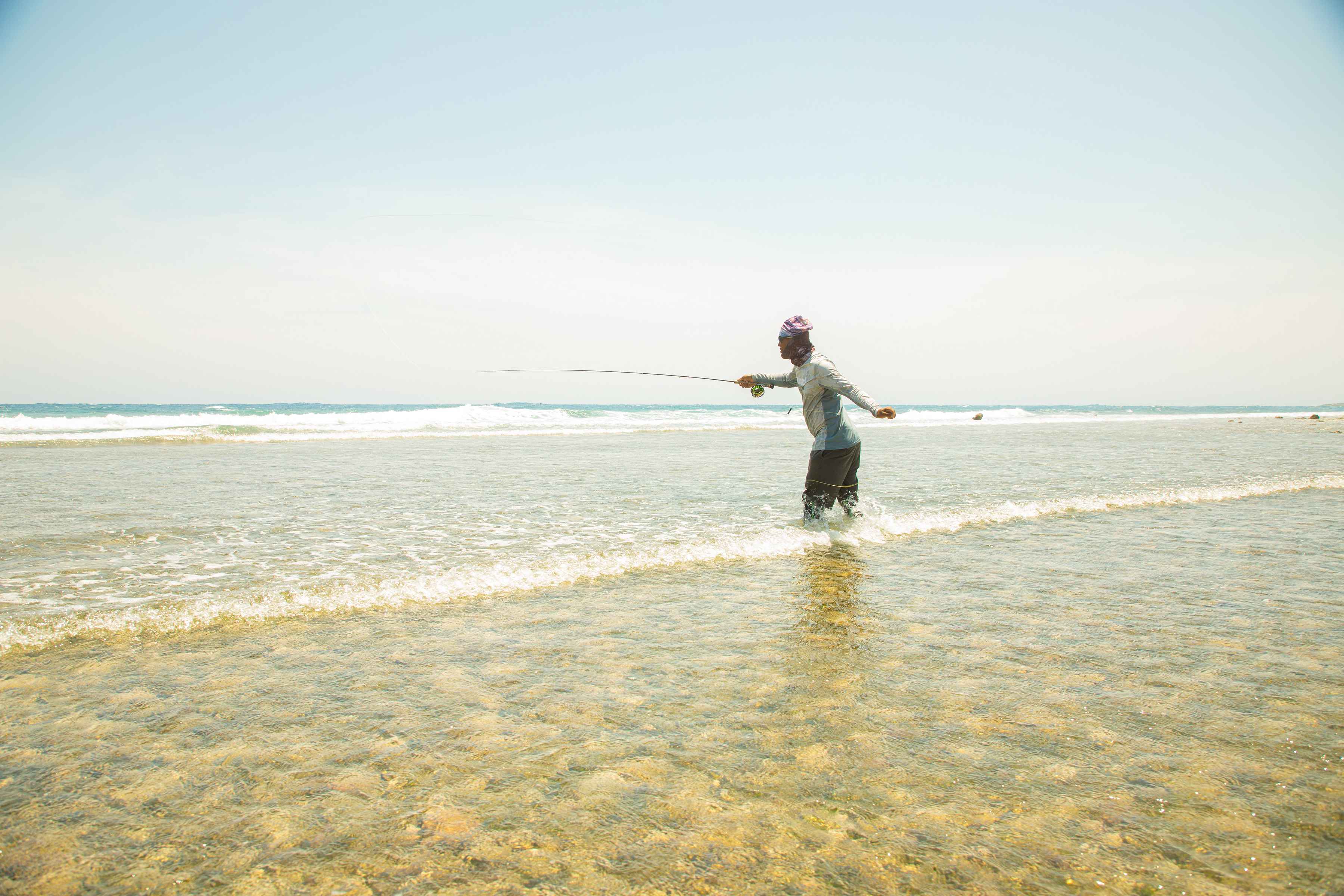Casting for Roatan "beach bones" (photo: Earl Harper). roatan bonefish fly fishing