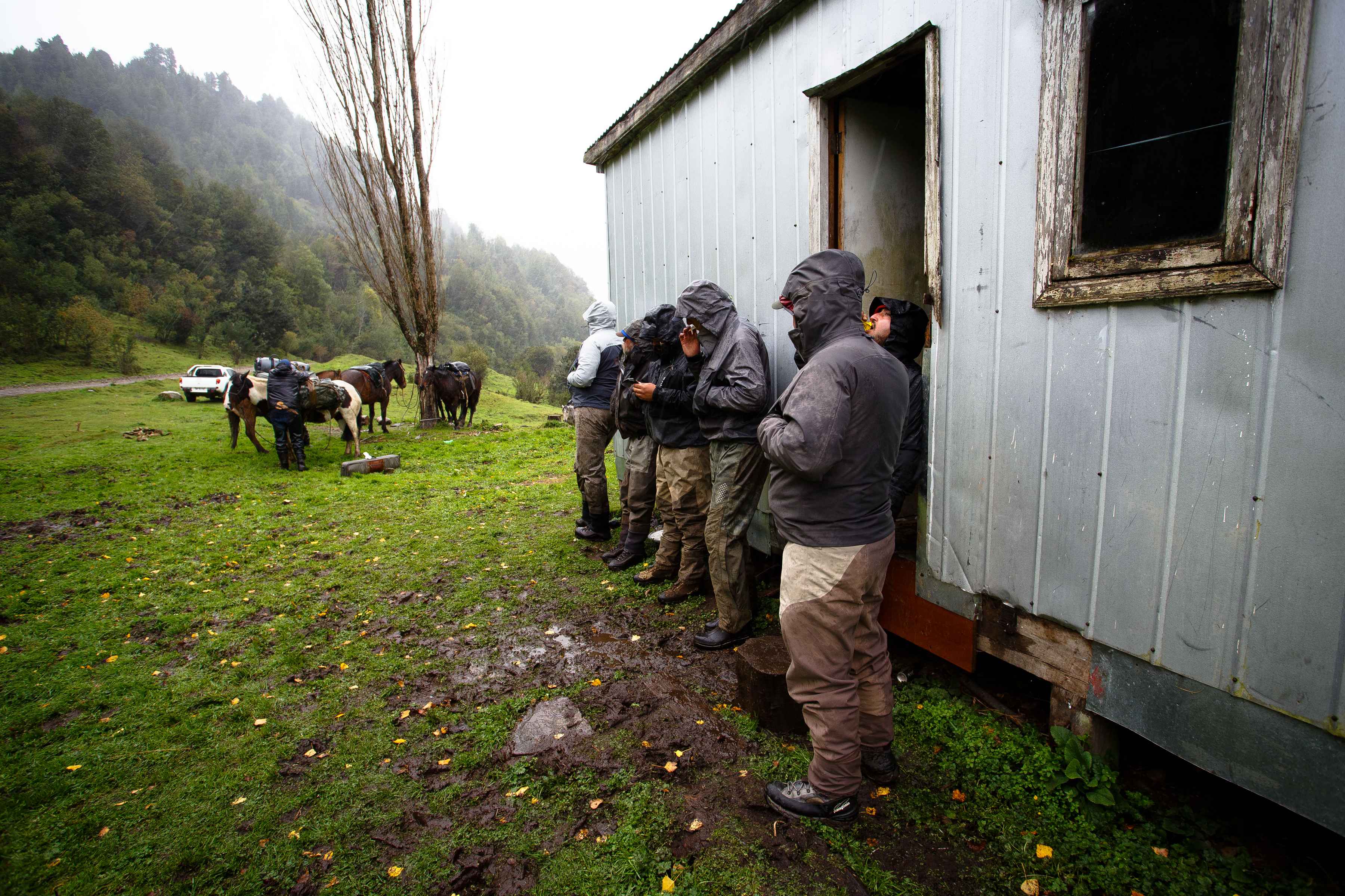 Seeking shelter as gaucho Jorge Martel fits the horses for the pilgrimage to the middle Rio Blanco valley (photo: Chad Shmukler). river of dreams horseback trip