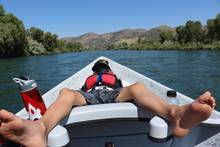 child in a drift boat