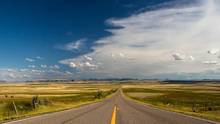 montana farm road blue skies