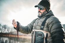 fly fisherman holding musky fly