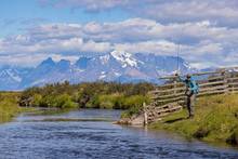 The famed Torres del Paine massif looms in the distance while an angler casts to a rising brown trout (photo: Earl Harper). torres del paine region fly fishing