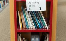 fly fishing books on shelf