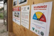 Photo: Tim Romano. high water temperatures drought warning sign river access