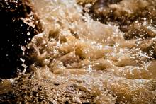 rushing brown filth water