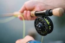 Photo: cc2.0 uncredited/modified. fly fisherman holding fly rod and reel