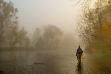 wading angler fly fishing