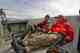 Researchers Sandy Milner (right) and Fred Windsor (left) eat lunch on the Capelin as the boat departs Wolf Point Creek for the teams next sampling site in Glacier Bay National Park (photo: Lesley Evans Ogden). researchers in glacier bay