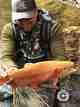 An angler shows off his catch of a palomino trout in West Virginia